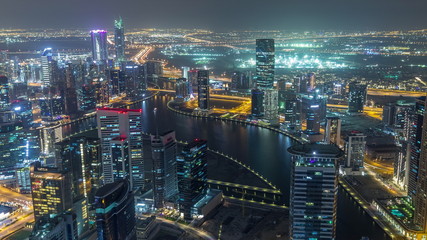 Fototapeta na wymiar Panoramic aerial view of business bay towers in Dubai night timelapse.