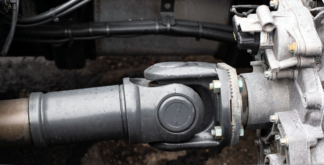 Cardan transmission of a truck transmitting torque. Drive shaft close-up, propeller shaft