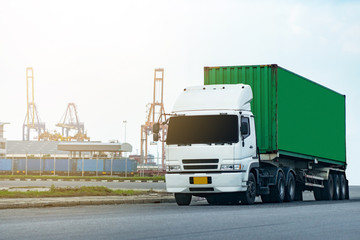 Cargo green Container truck in ship port Logistics.Transportation industry in port business concept.import,export logistic industrial Transporting Land transport on Port transportation storge