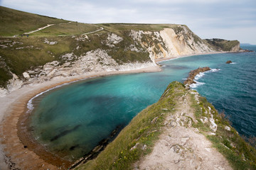 views of rock formations and beach at durdle dor
