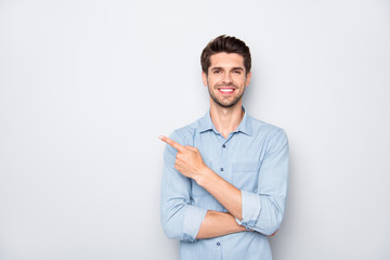 Portrait of positive cheerful guy promoter point index finger recommend ads select suggest adverts wear casual style clothes isolated over grey color background