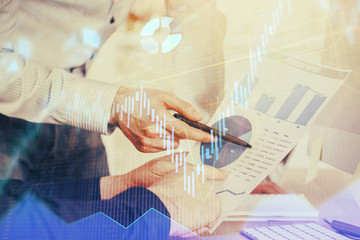 Fototapeta premium Financial trading graph double exposure with man desktop background.