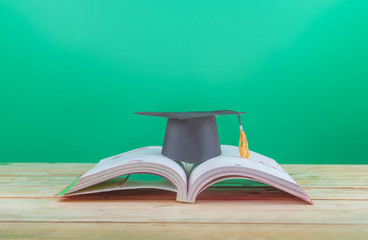 Back to school concept. Graduation cap with books on the table