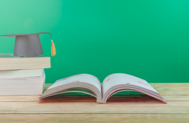 Back to school concept. Graduation cap with books on the table