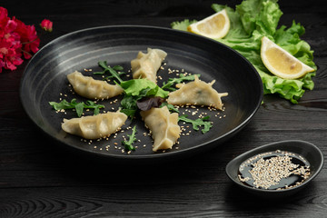 gedza syumai steamed chinese dumplings with shrimp and vegetables, served with sauce