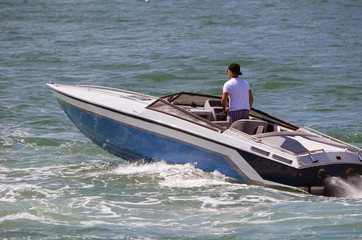 High-end blue and white inboard engined motorboat.