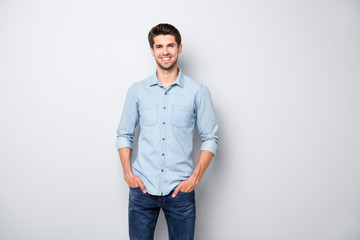 Portrait of positive cheerful dreamy emotions man have fun free time with his colleagues after work put hands pockets wear casual style clothing isolated over grey color background