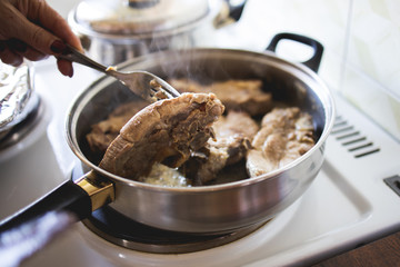 Pork chop is fried in a pan stock photo