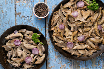 Delicious fried mushrooms in pan on table