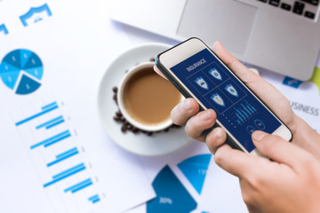 Hand holding smartphone to search for insurance online. Insurance concept