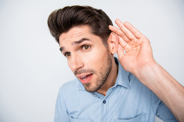What did you say. Close up photo of astonished guy feel curious hold hand near ear listen unbelievable unexpected rumors about his colleagues wear casual style clothes isolated grey color background