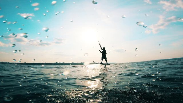 One person falls from board while kite surfing.