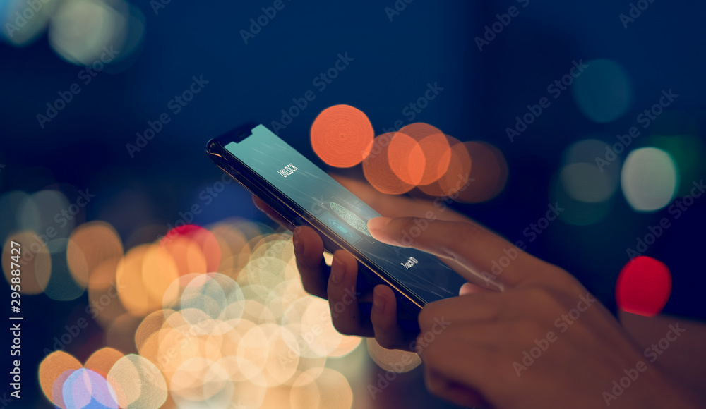 Poster close-up of hands scanning fingerprint on smartphone to unlock mobile phone on bokeh colors light in