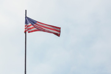 American flag flies against the blue sky.