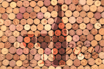 Abstract background of used old wine corks with silhouette of wine bottle and wine glasses as basis for menu or advertising in bar or restaurant