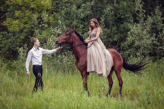 Love story. Two lovers in the forest. Photo with a horse