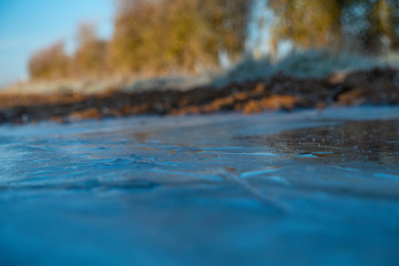 Frozen puddles on mud farm track