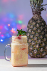 Pina colada jug with colorful lights background