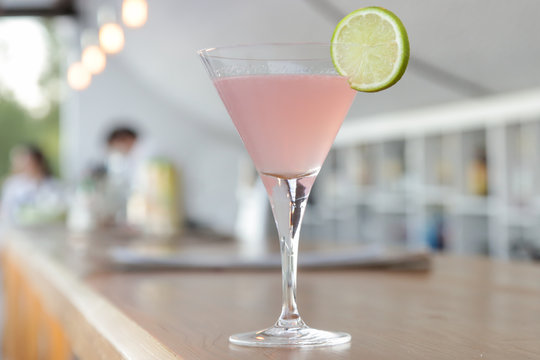 A glass of Cosmopolitan drink on the bar
