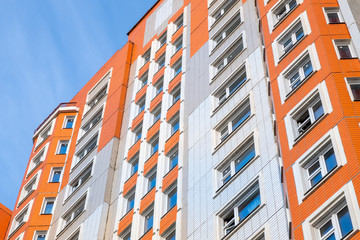 Common high rise apartment building. Orange and white. Moscow.