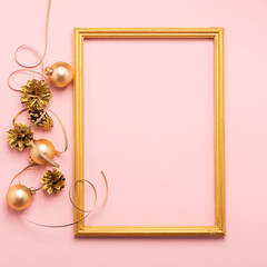Fototapeta na wymiar New Year Christmas frame layout balloons streamers shiny cones of gold color pink background. Holiday concept. Flat lay.