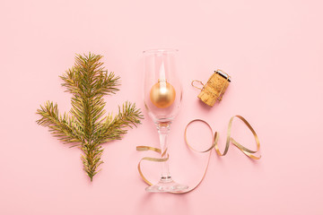 Christmas New Year balls glass goblet curl of serpentine, cork branch of spruce tree of gold color on pink background.