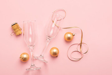 New Year or Christmas layout balls balls Serpentine cork from a bottle of gold color pink background. Holiday concept.