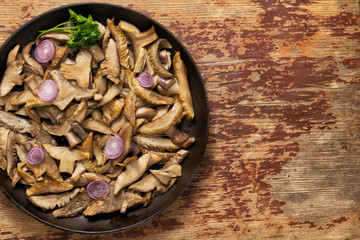 Delicious fried mushrooms in pan on table