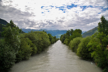 Plakat mountain river with trees and clouds