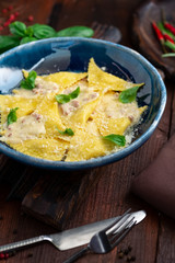 Traditional Italian ravioli stuffed with potatoes and cheese in a creamy Carbonara sauce. Italian cuisine rustic style
