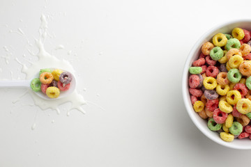 Top view plastic spoon and cereal bowl