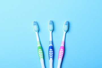 Toothbrushes on a colored background top view. Oral hygiene.