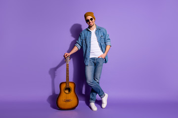 Full length body size photo of cheerful positive cute attractive handsome music maker leaning upon...