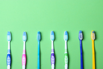 Toothbrushes on a colored background top view. Oral hygiene.