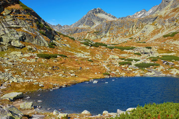 Beautiful lake over Skok wterfall - Skokom pleso in vibrant blue among peaks of High Tatra mountains © andras_csontos
