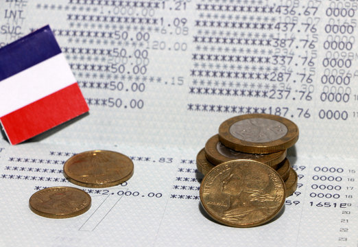 Heap of French franc coin money and mini France flag on the book bank. Concept of Saving money.