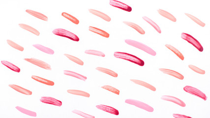 Nail polish strokes pattern background in nude pink, peach, red colors. Abstract paint blots background for beauty and fashion, copy space