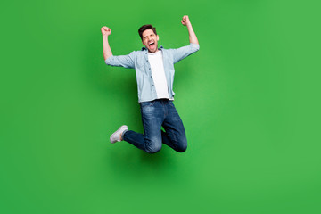 Full length body size photo of cheerful rejoicing crazy man shutting his eyes in a fit of...