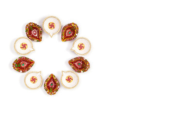Happy Diwali - Clay Diya lamps lit during Dipavali, Hindu festival of lights celebration. Colorful traditional oil lamp diya on white background. Copy space for text.