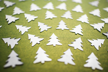 Festive silver Christmas tree-shaped confetti. Mother of pearl green background. New Year and...