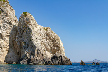 Seascape - rocks of various heights surrounded by blue water