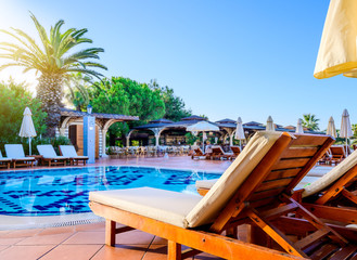 Beach lounger and swimming pool in luxury resort