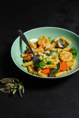 pasta salad, vegetables, mix leaves (tomato, onion, lettuce, chard, arugula and more italian ) menu concept. food background. copy space. Top view