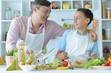 Close up portrait of father and son cooking
