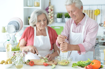 Close up portrait of senior couple cooking