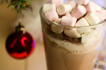 Hot chocolate with marshmallows and whipped cream with Christmas bauble