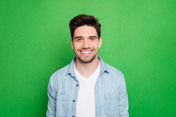Close up photo of amazing macho guy revealing perfect white teeth wear casual denim shirt isolated over green color background