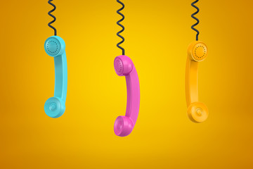 3d rendering of three colorful retro telephone receivers hanging on yellow background