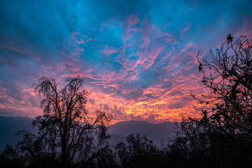 A fiery sunset in the mountains over looking a valley in central Chile. 