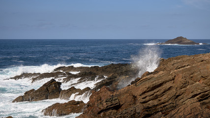 olas rompiendo contra las rocas en un acantilado